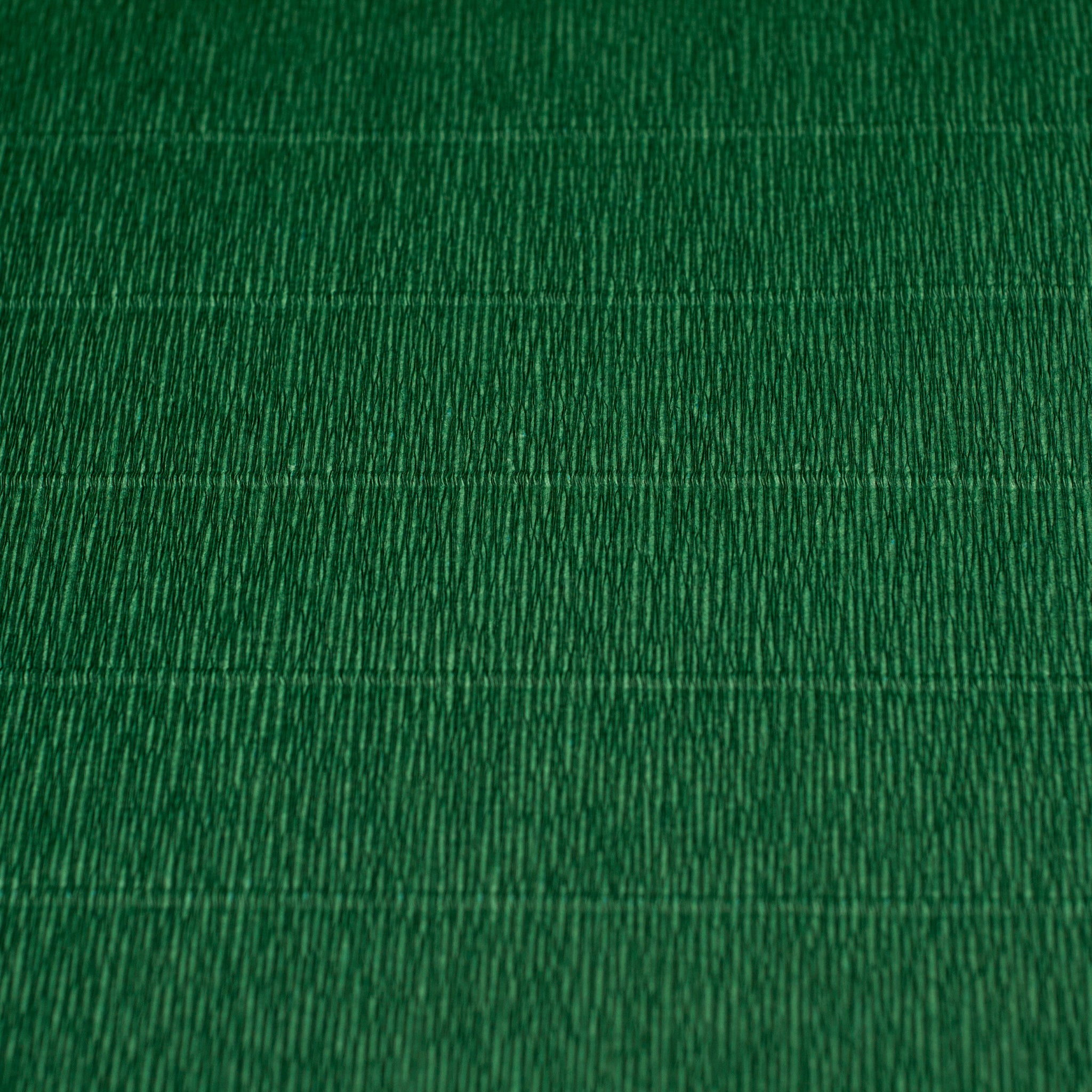 A close-up image of a green crepe paper with texture visible.