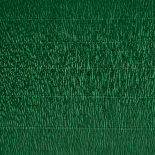 A close-up image of a green crepe paper with texture visible.